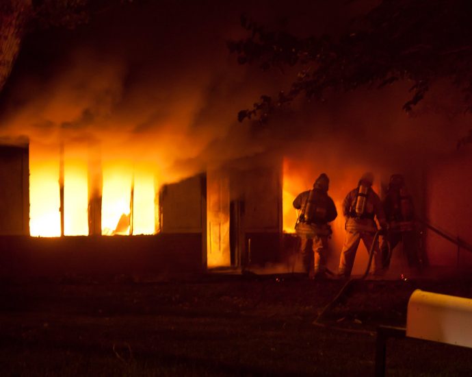 Firefighters entering housefire